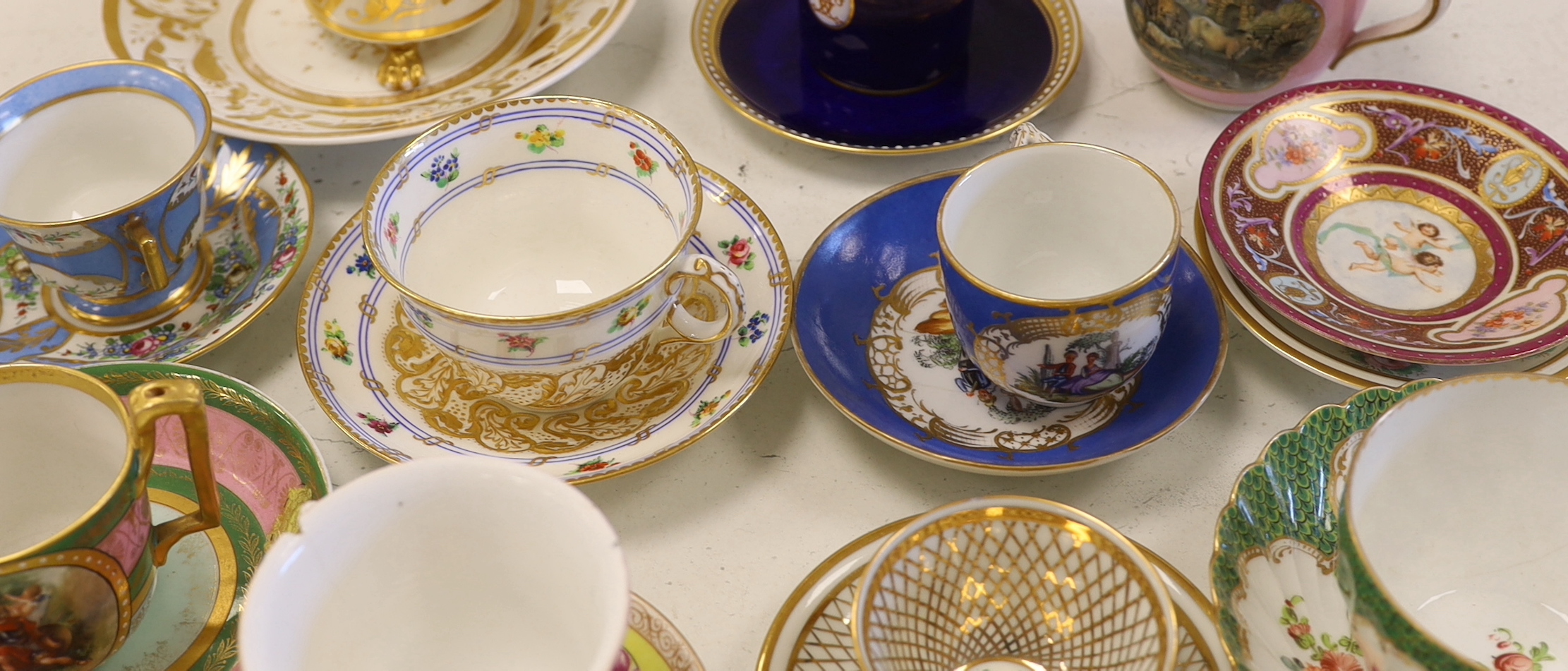 A collection of European cabinet cups and saucers, including a gilded Berlin cup and saucer (12)